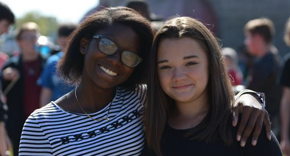 two students smiling at the camera