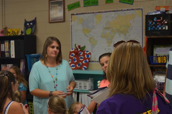 teahcers talking with students at classroom 