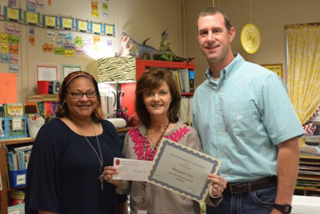 three staff members witg diplomas