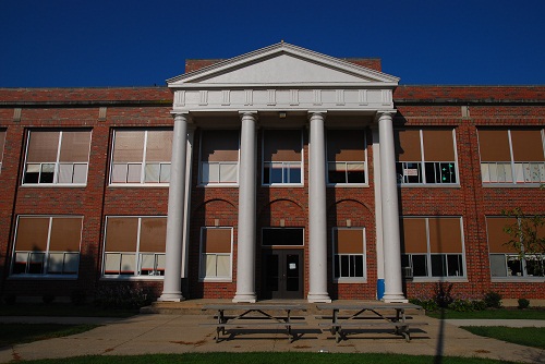 Brick building front with white pillars