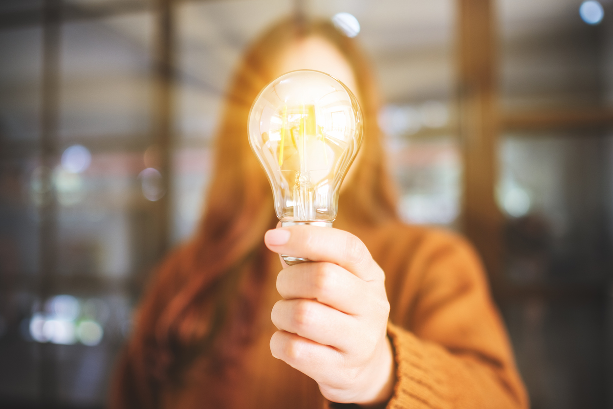 women holding a light bulb