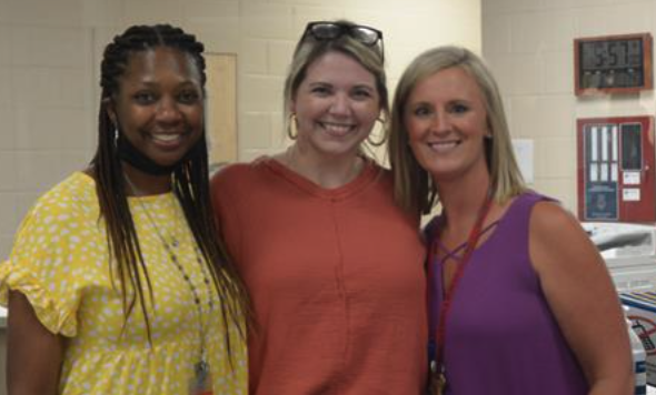 three teachers smiling at the camera