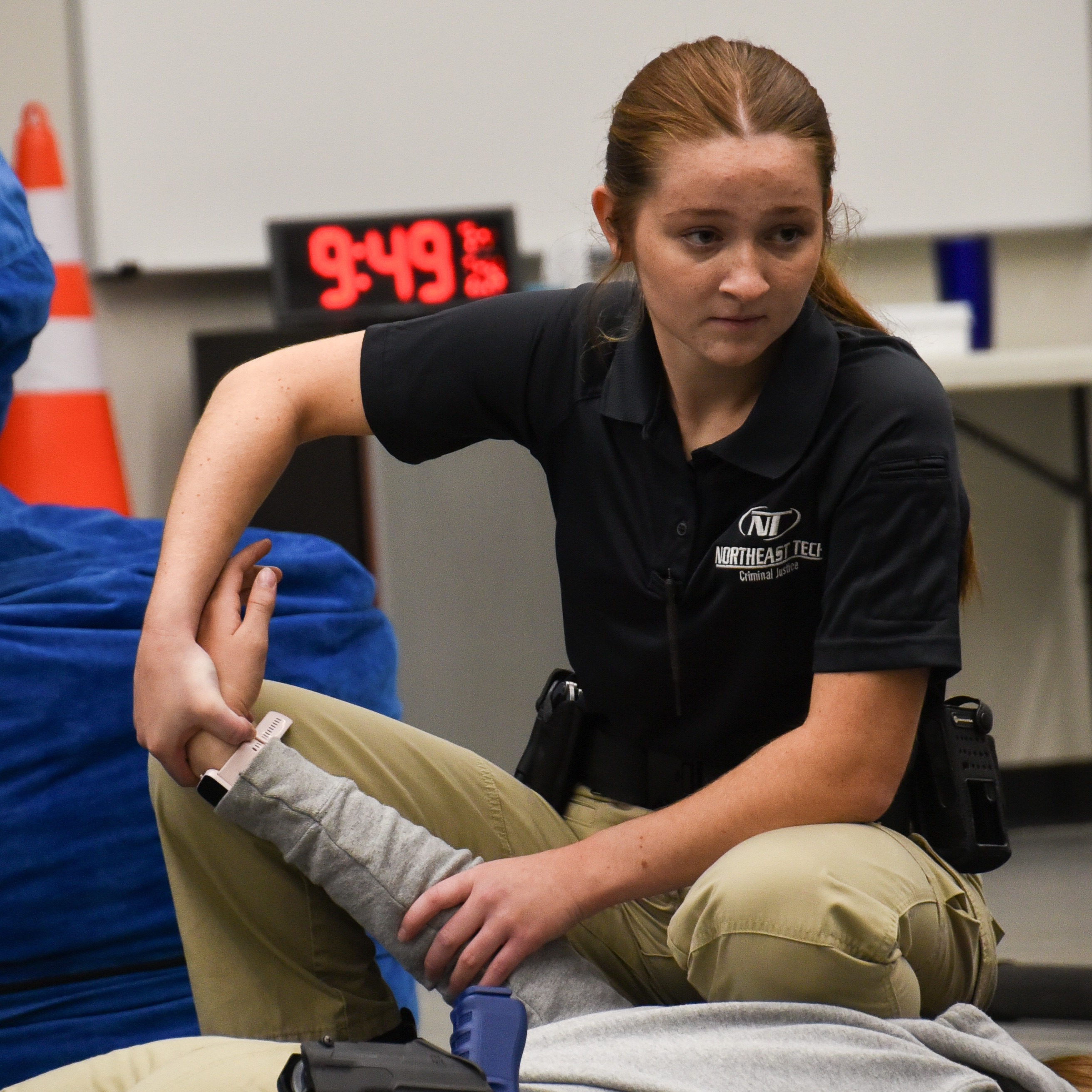 female criminal justice student practicing skills