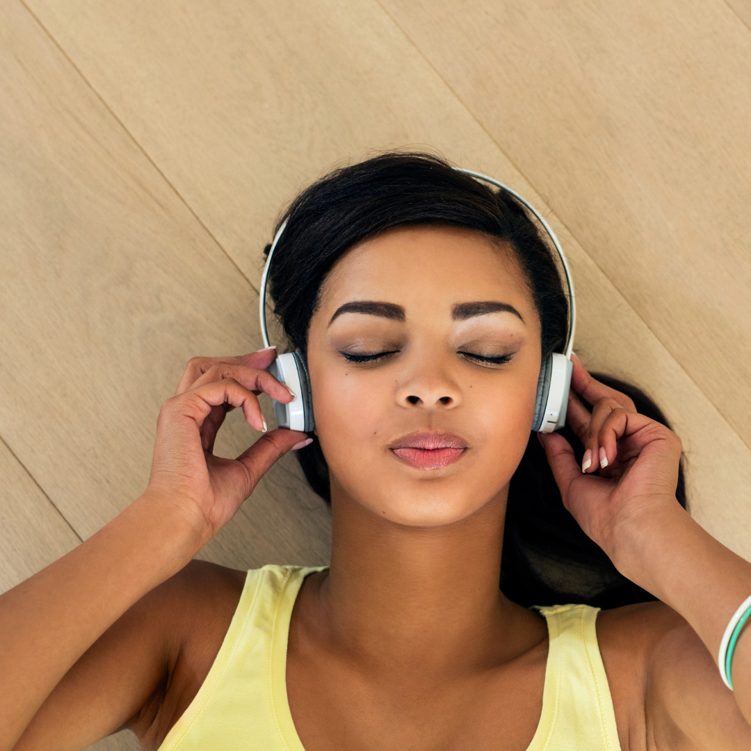girl listening to music on floor