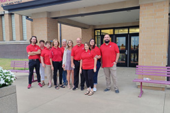 Teachers smiling outside the school