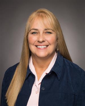 A woman with blonde hair smiling