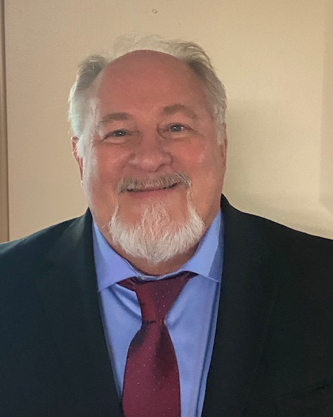 A man with short hair smiling