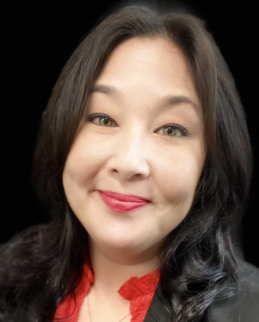 A woman with black hair smiling