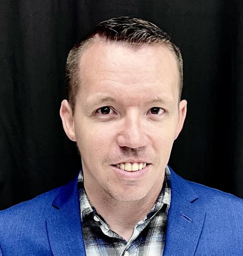 A man with short hair smiling