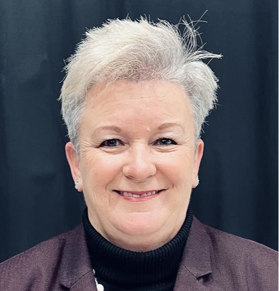 A woman with short gray hair smiling