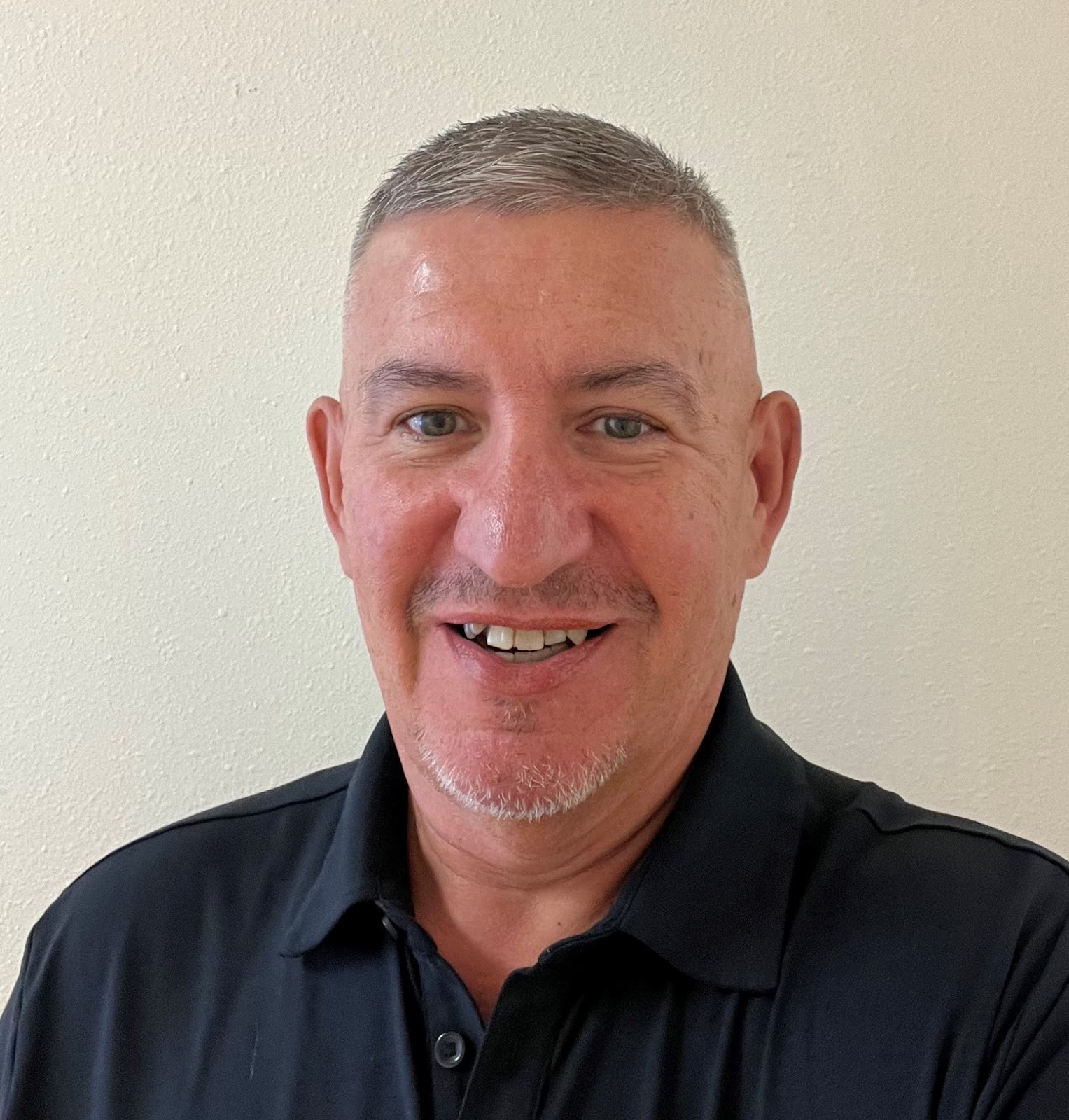 A man with short hair smiling