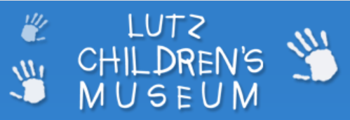 A blue background featuring the text 'Lutz Children's Museum' in white, playful font, accompanied by handprint illustrations.