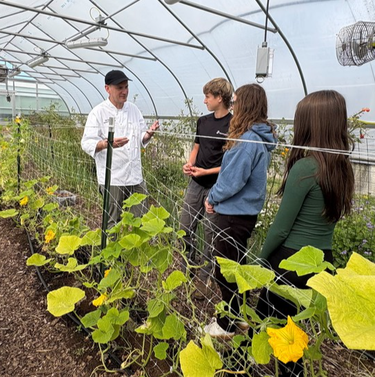 Chef Tom in the ASTE Hoop house