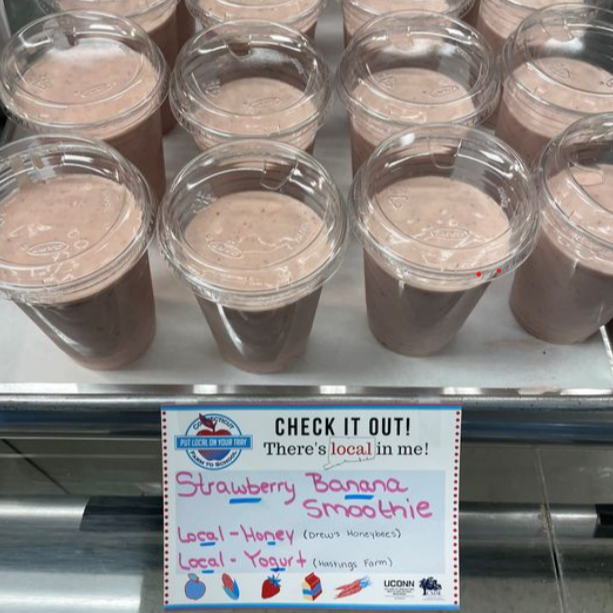 A close-up view of several slices of bread spread with peanut butter and topped with jelly, arranged neatly on a table.