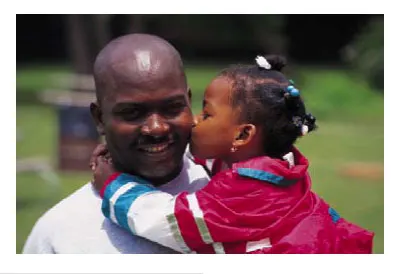 girl kissing dad on the cheek