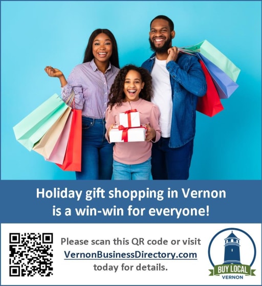 A family of three, consisting of a woman, a girl, and a man, stands together holding shopping bags and a gift box, promoting holiday shopping in Vernon with a QR code and website link below them.