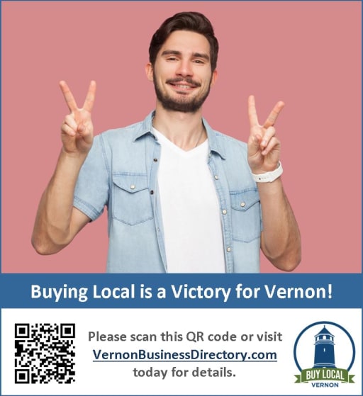 A smiling man with short dark hair and a beard is making a peace sign with both hands, promoting local business support with a QR code and website link below.