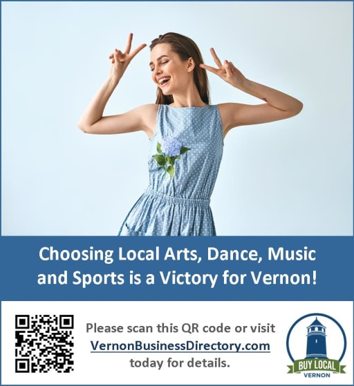 A joyful woman in a blue dress poses with a peace sign and a flower, promoting local arts, dance, music, and sports in Vernon.