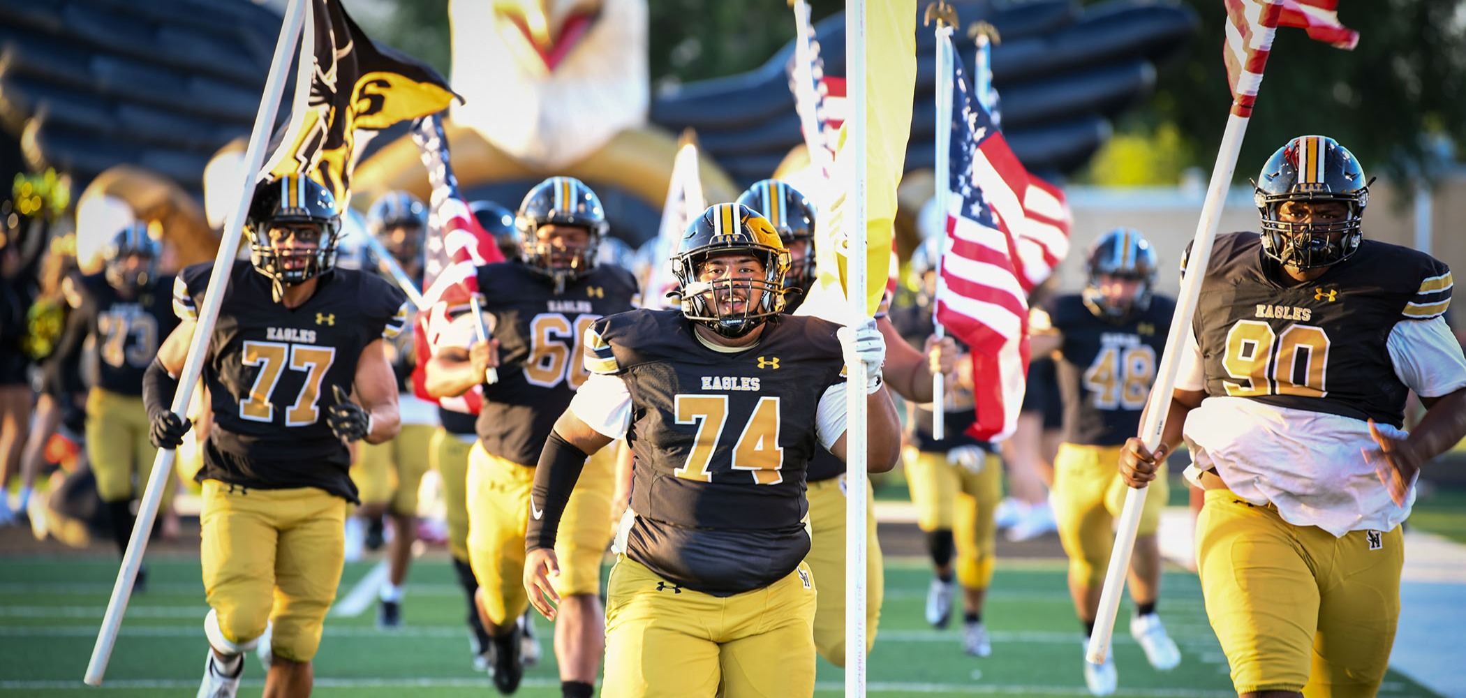 football team running with flags