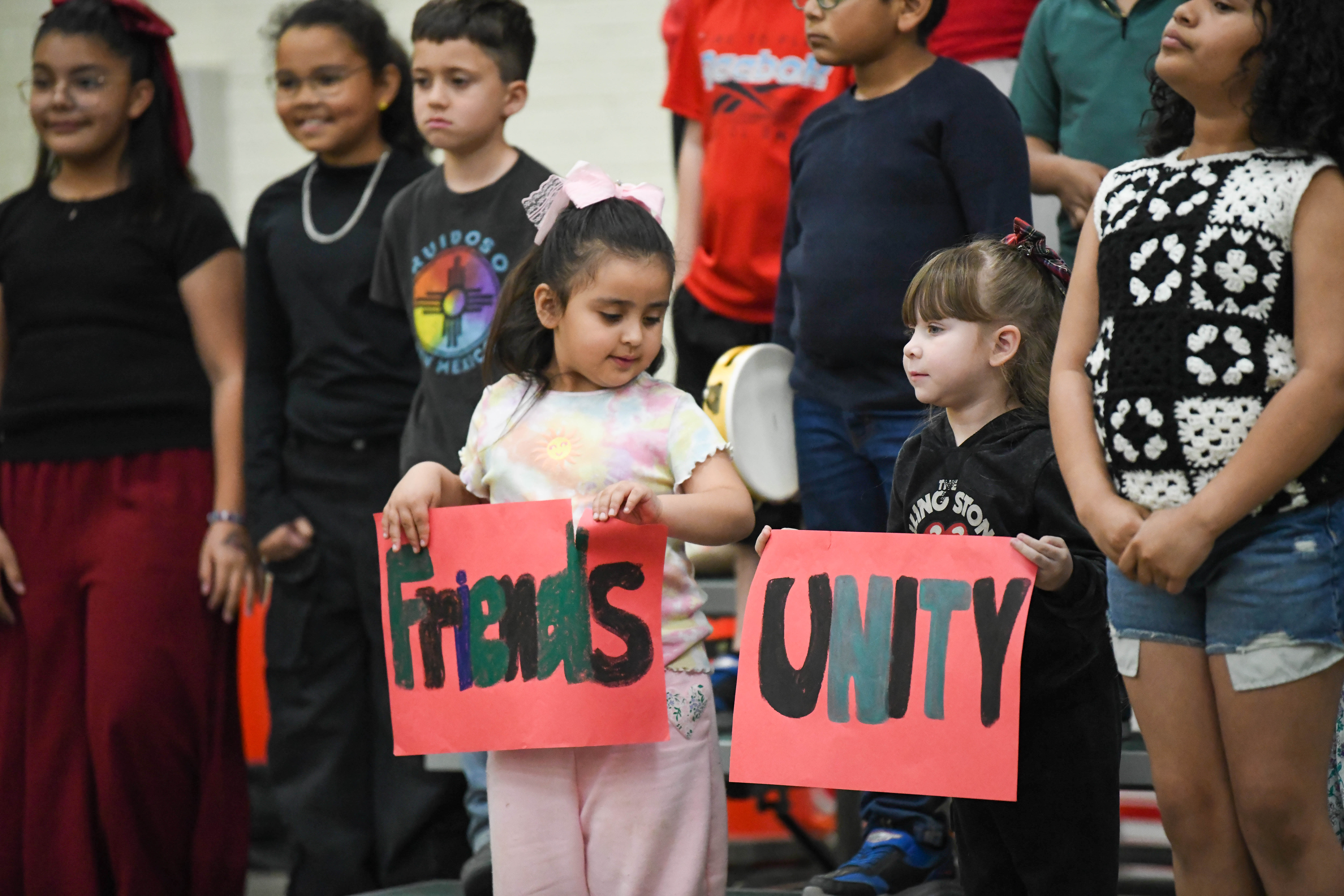 two little girls holding signs