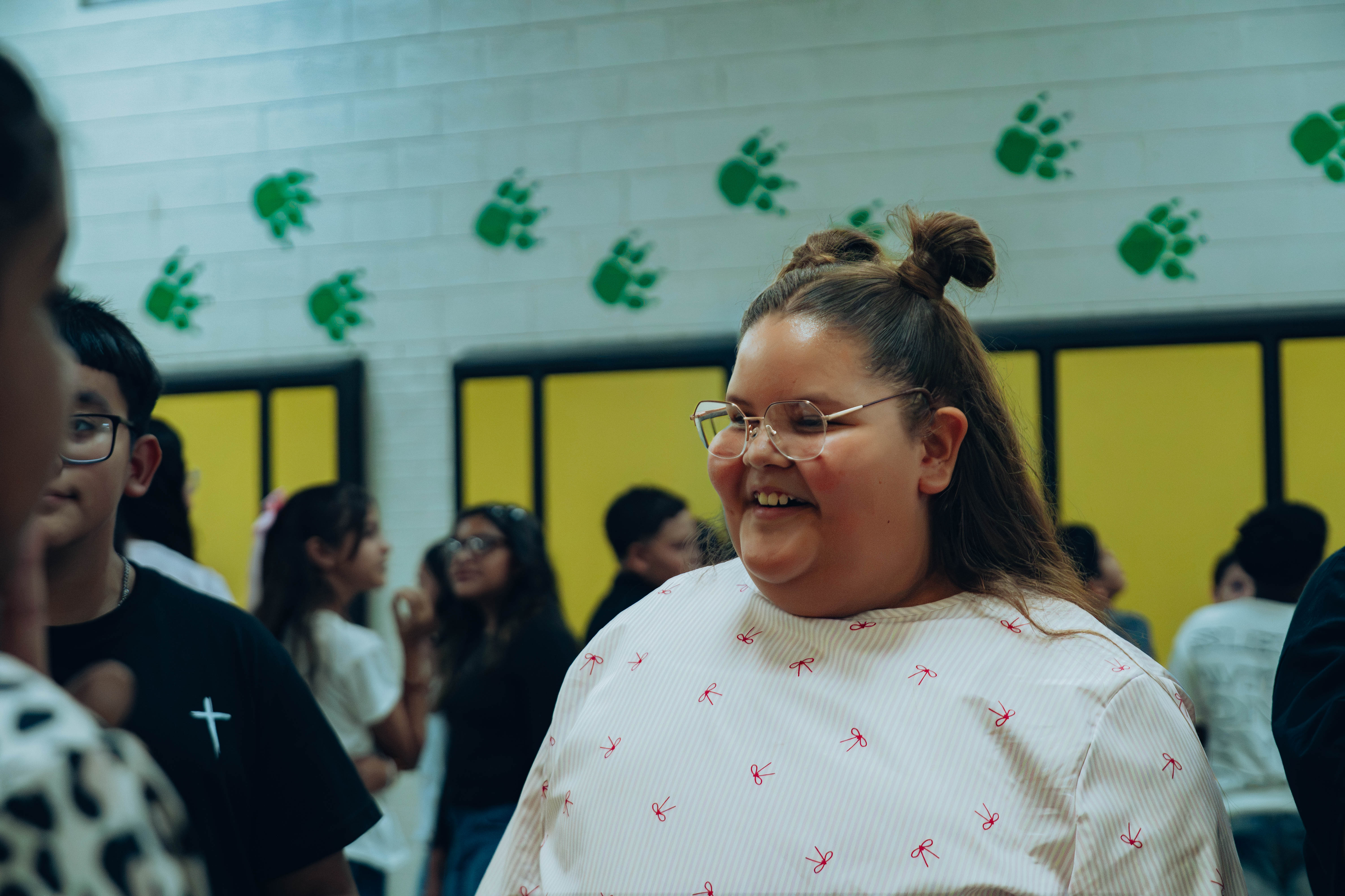 Student smiles during classroom activity.
