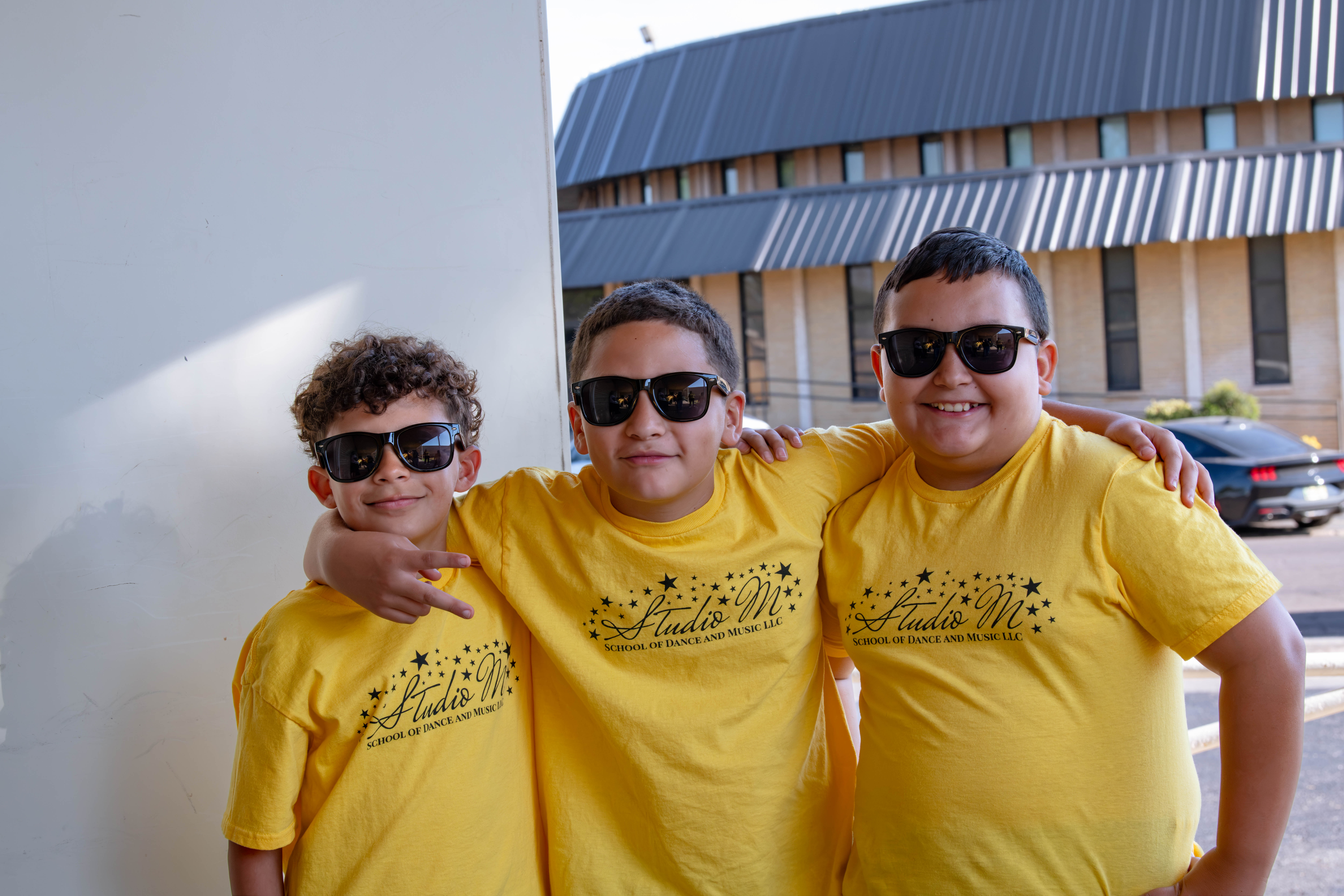 Boys posing with sunglasses during the Studio M Performance.
