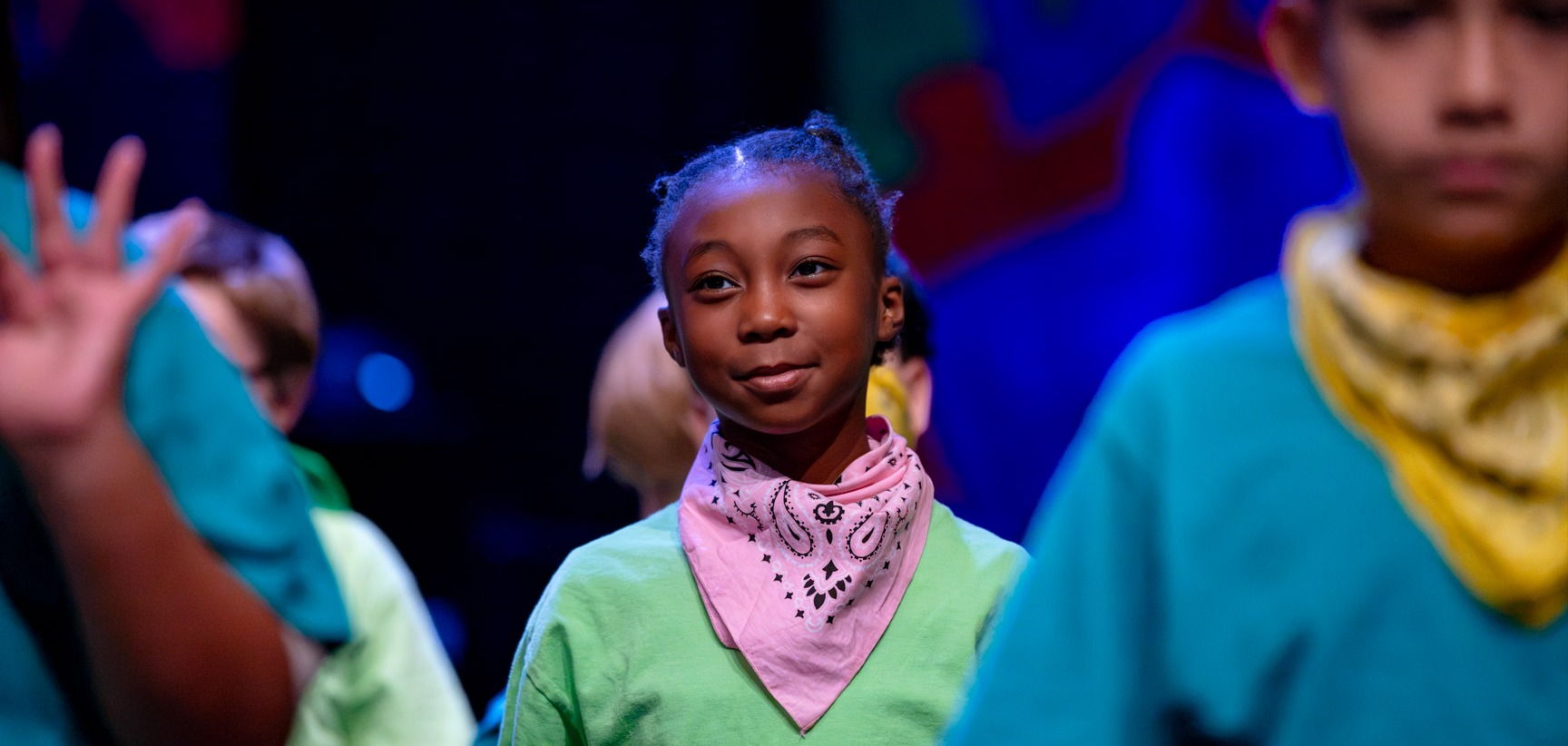 Student smiles as she performs choreography through the National Dance Institute of New Mexico Residency