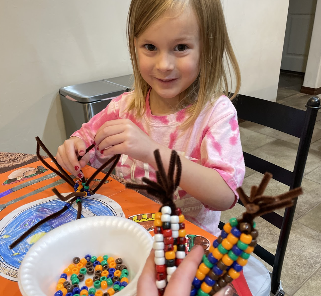 Kindergarten NASS student, Chandler, completing the Corn Craft.