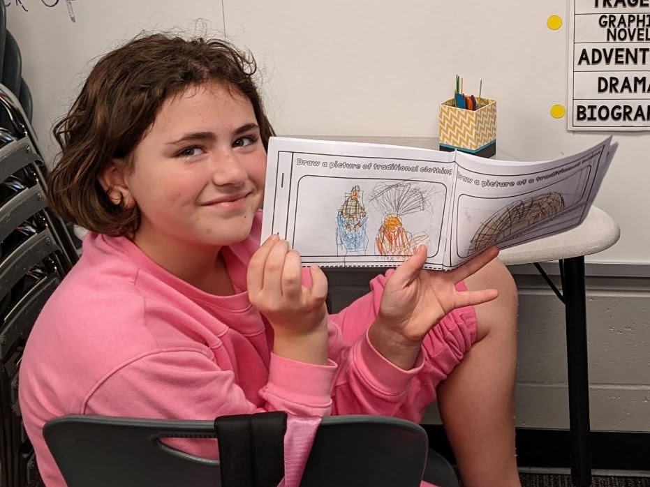 Students holding their school work