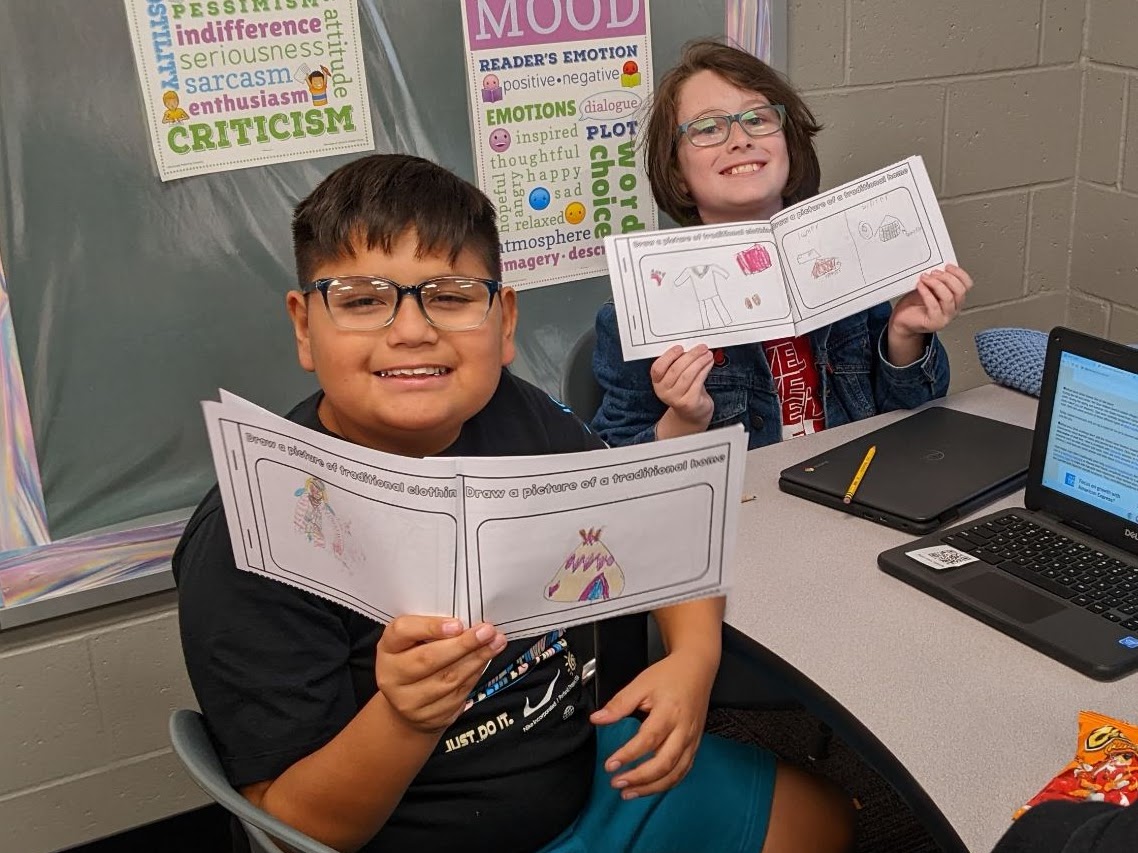 Students holding their school work