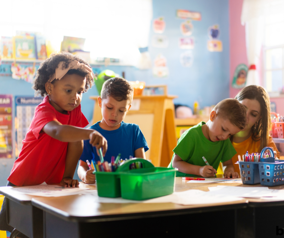 3 students playing at a table