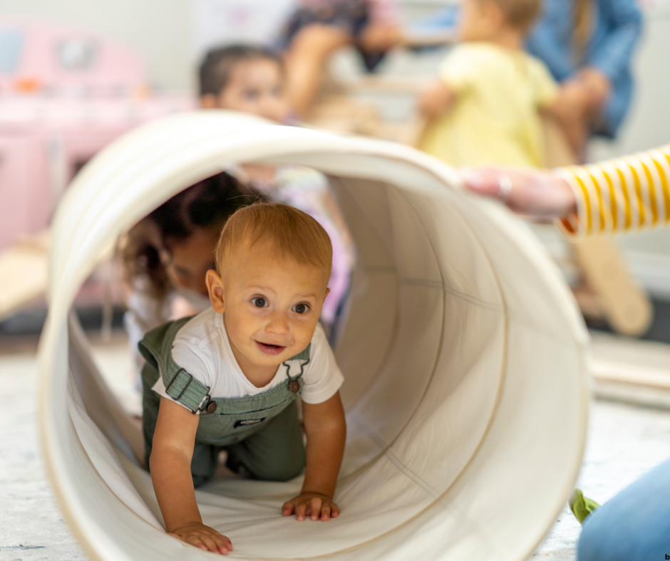 toddler climbing through a tunnel