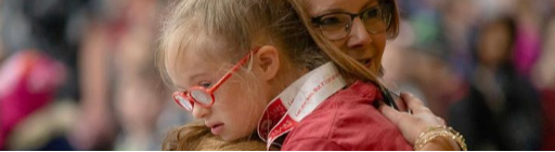 Principal hugging student