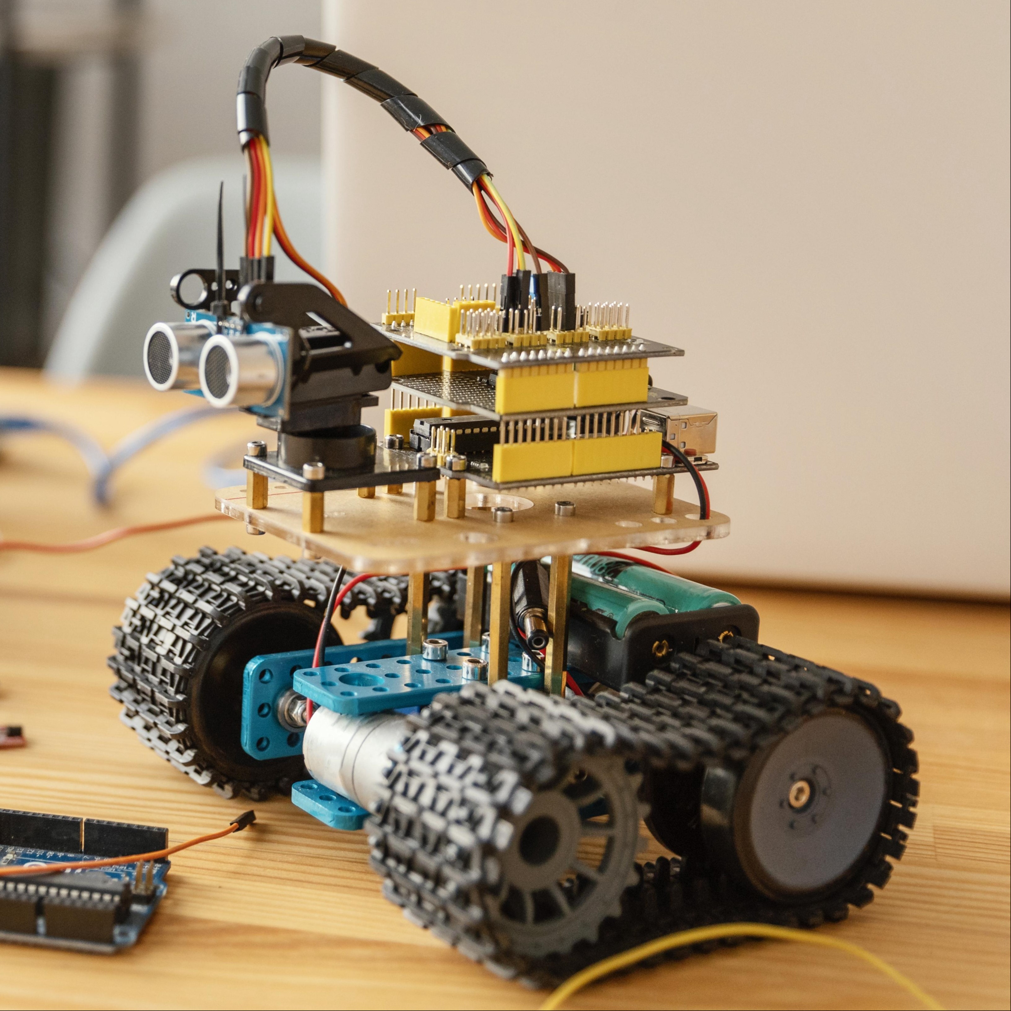 Tracked robot on desk photo.