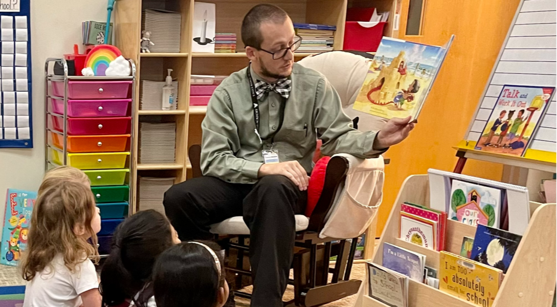 teacher reading picture book to students