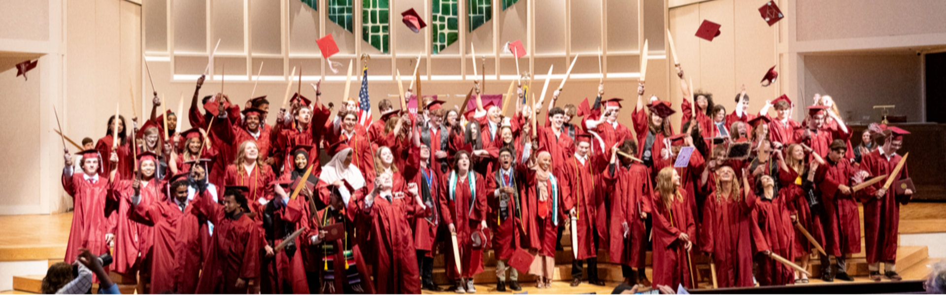 graduates tossing caps at commencement