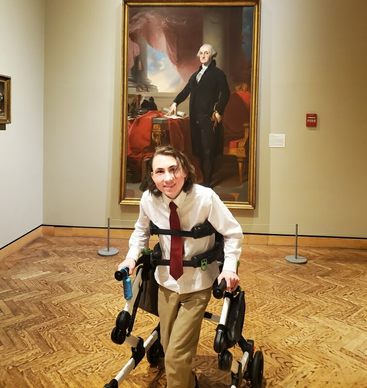 student in front of painting