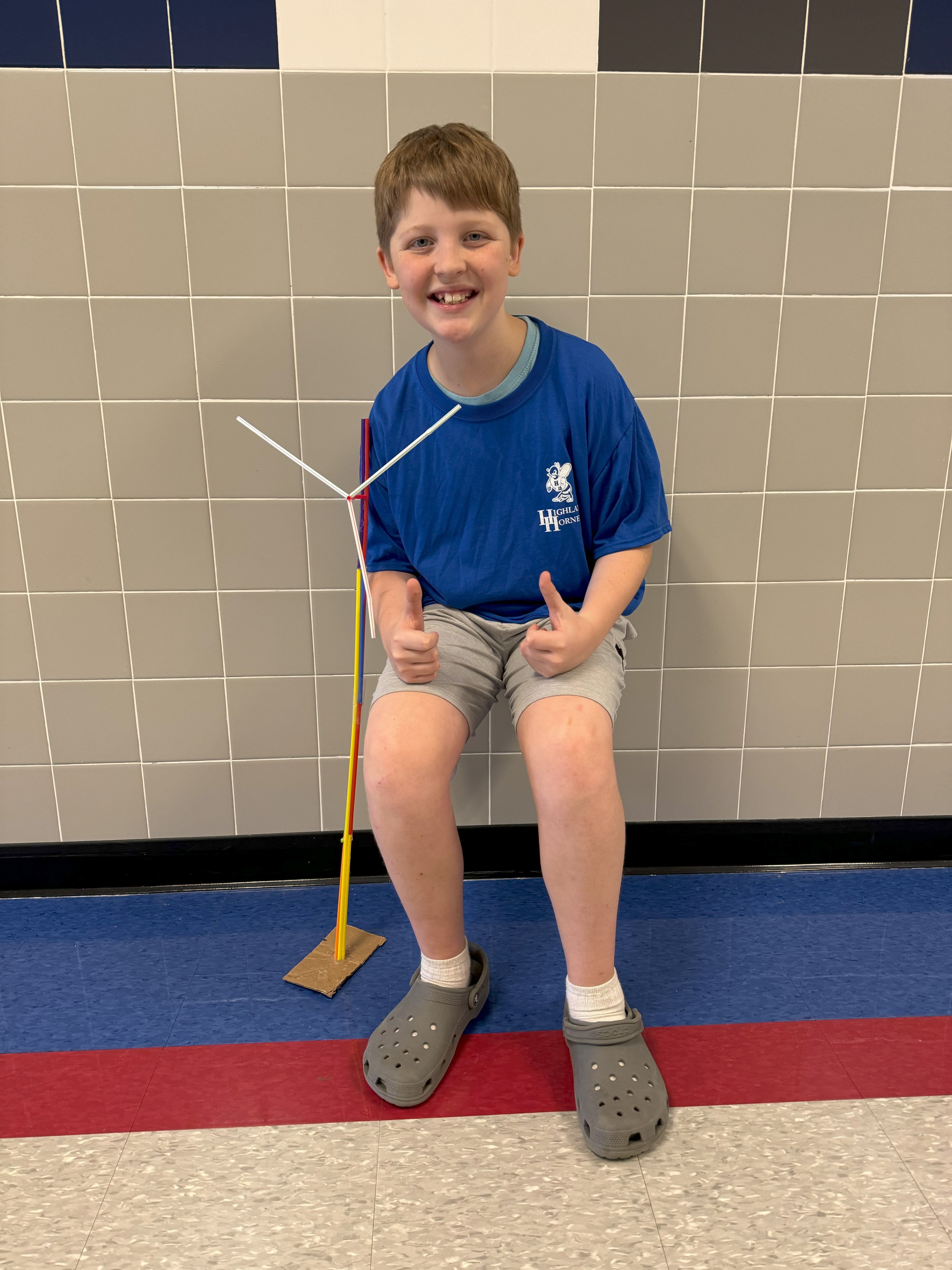 Student posing with his project