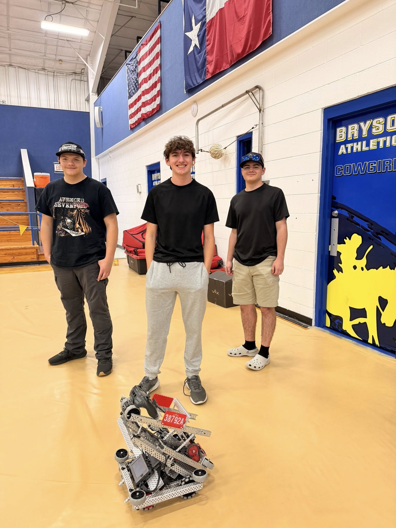 Team posing with robot