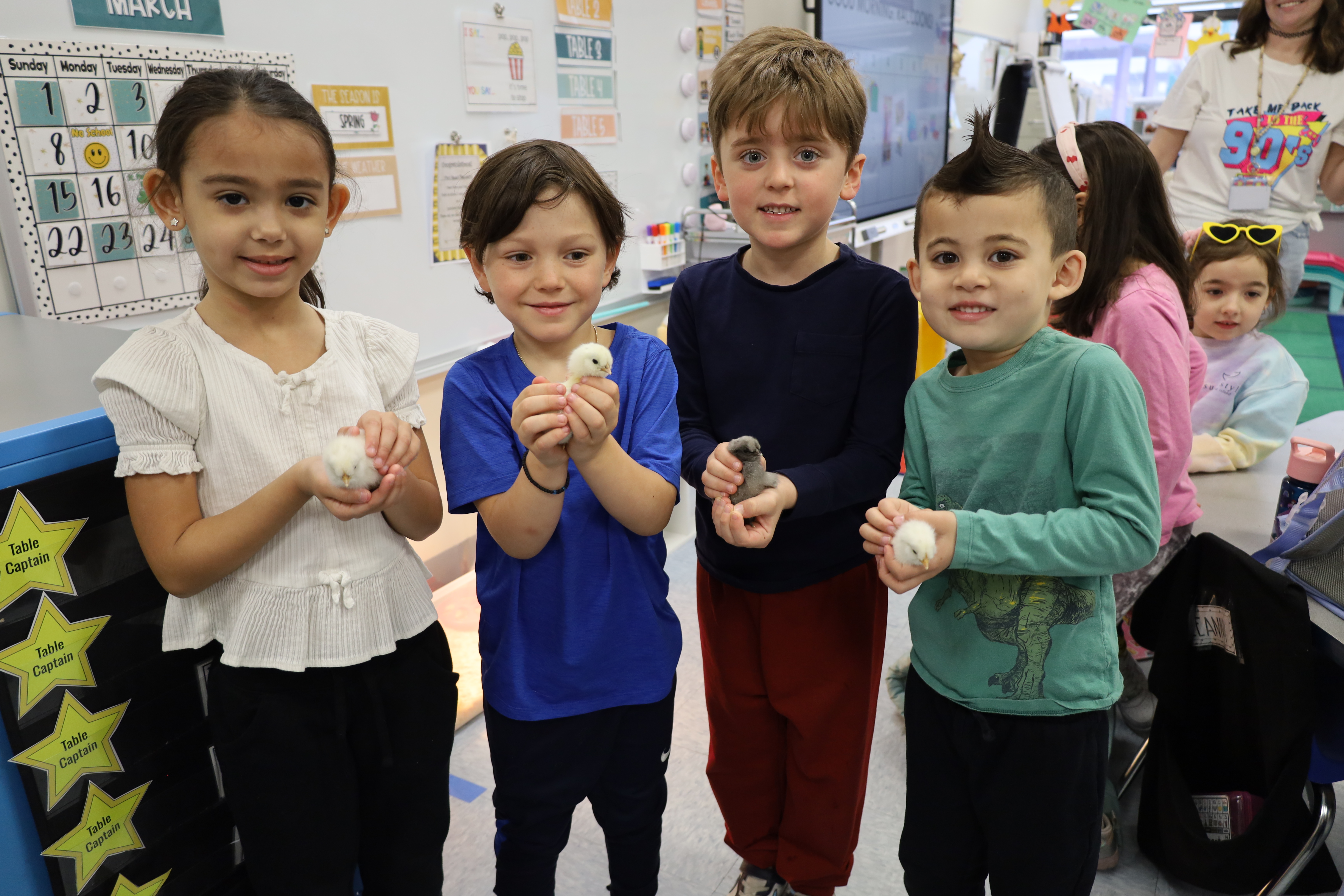 Students holding baby chicks.