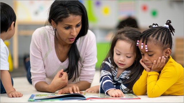 volunteer reading with students