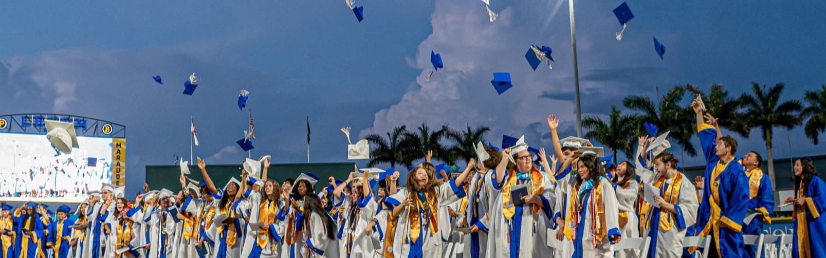 Class of 2026 Bayshore High graduates throw their graduation caps in the air.