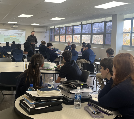 Father Ryan speaking to students during a discipleship program meeting.