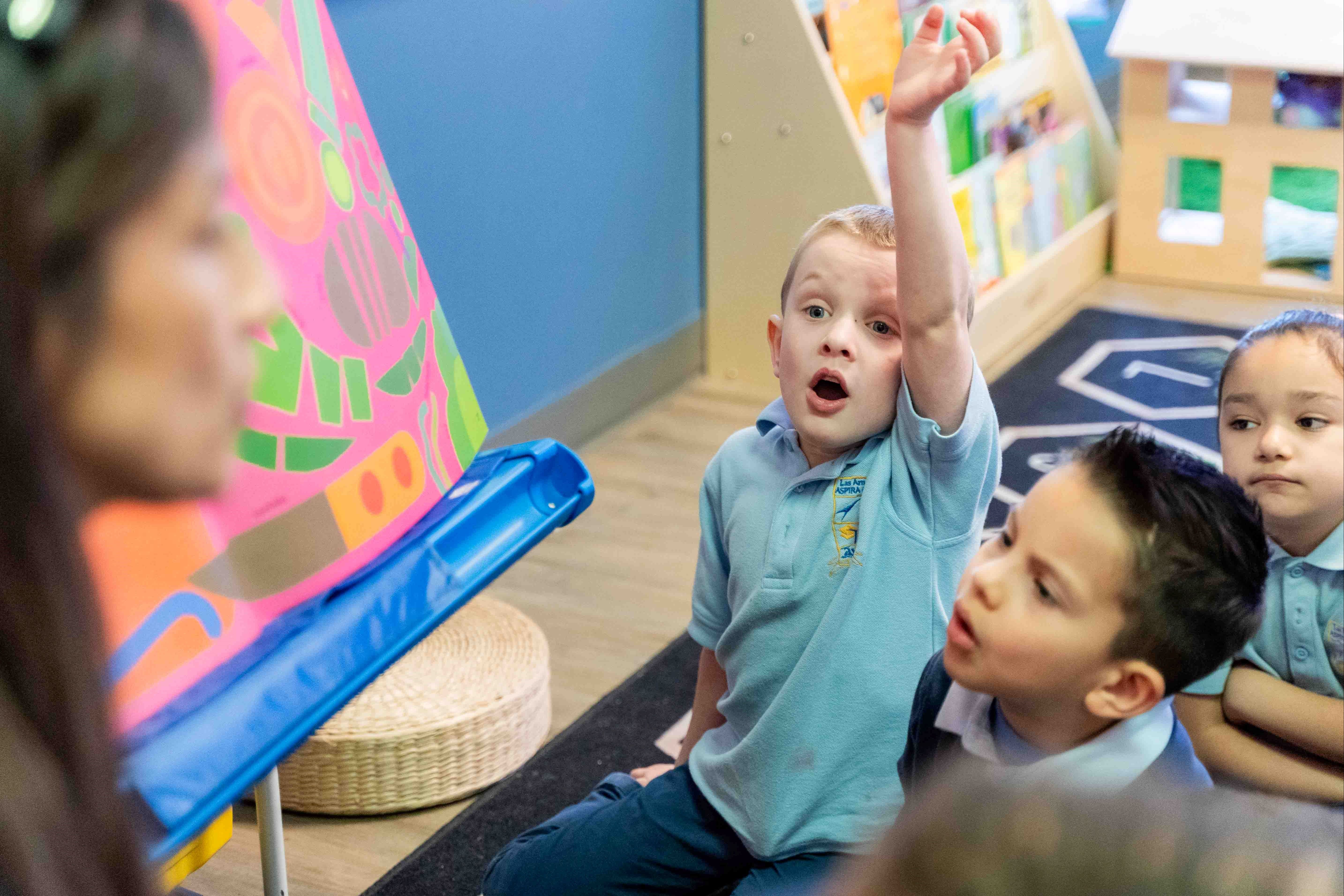 Kinder student raising hand