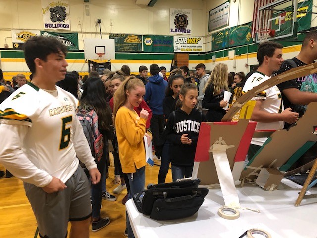 Students in a presentation project in the school gym