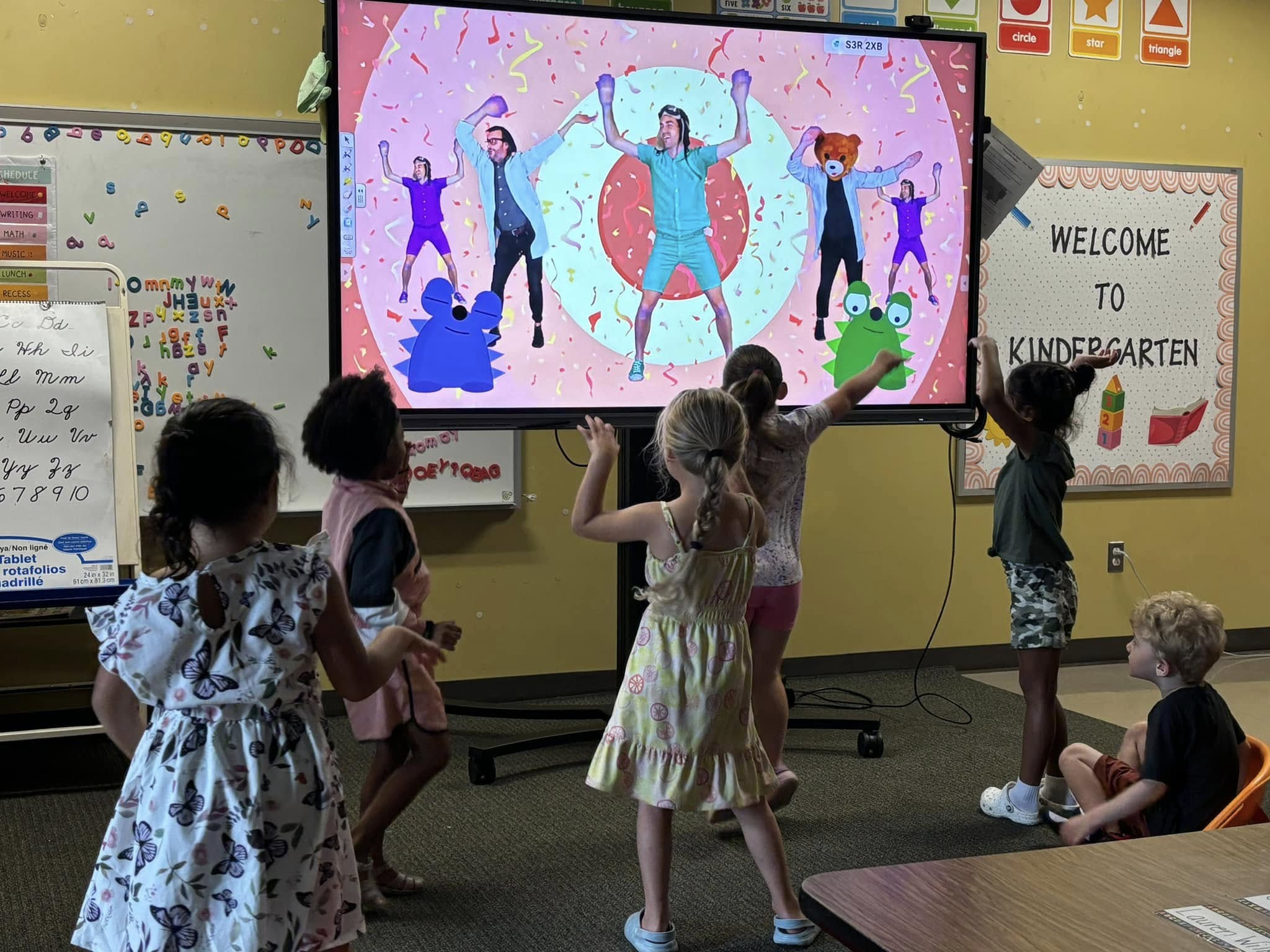 EJE Students dancing in front of a TV