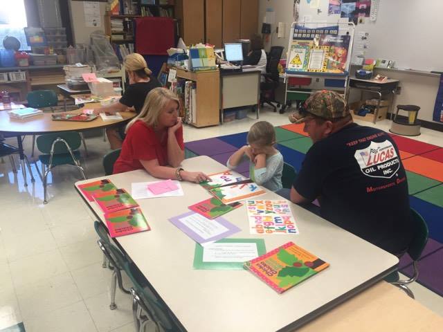 Photos of the parents working with their children on the classroom