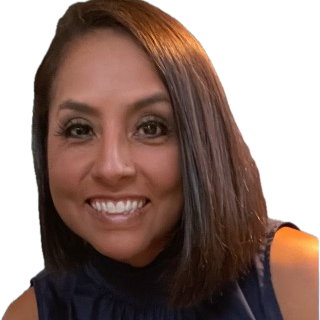 A woman with shoulder length brown hair wearing a dark shirt while smiling.