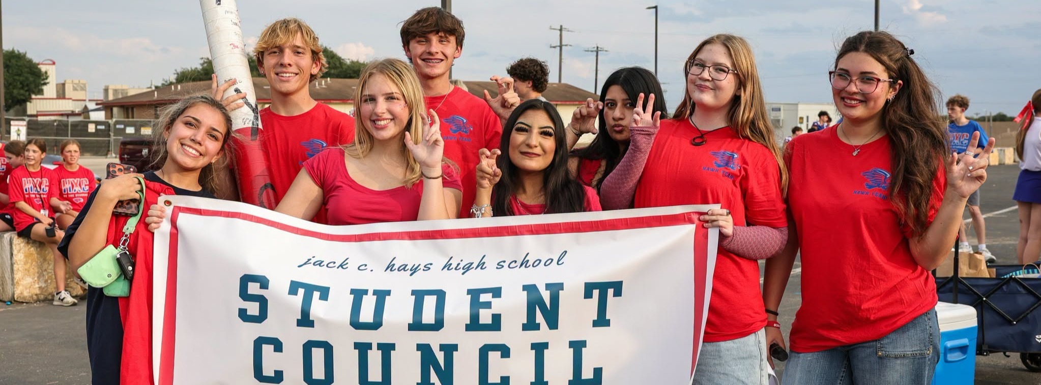 A group of students carrying a banner for student council