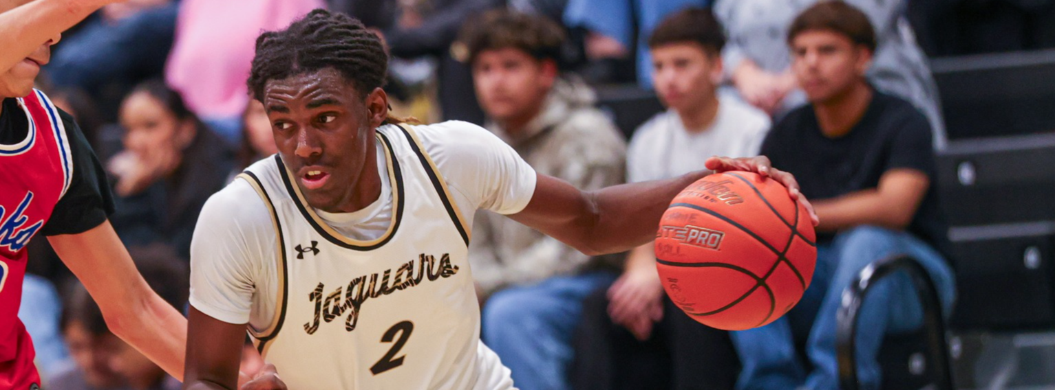 A JHS basketball player dribbling